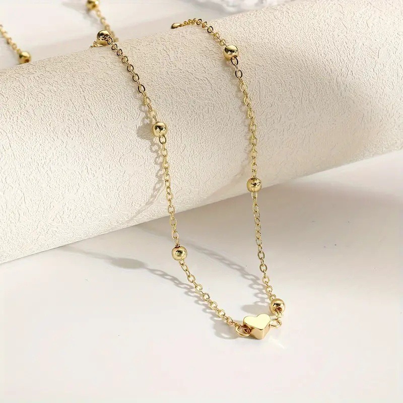 Sierlijke gouden hartvormige t - Body Jewelry recensie en prijs